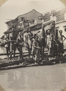 People standing by a canal near Baishui, southern Fujian province