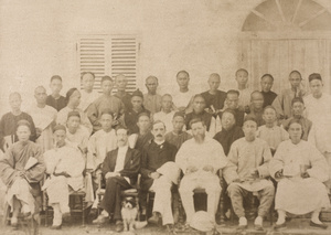 A group of unidentified Chinese men with three foreigners and a dog