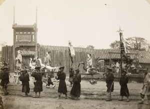 Bearers carrying paper figures for burning at a funeral, Beijing