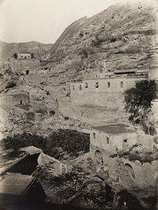 A defensive wall and gateway in a mountainous area