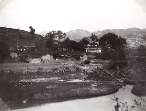 A river, canal, temple, and village houses