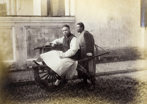 Passenger on wheelbarrow taxi, with barrow pusher, Peking