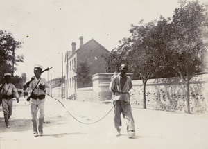 Japanese soldiers bringing in a prisoner, Tientsin