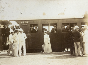 Civilians and British soldiers, at a railway station