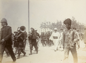 Chinese band, civilians and allied forces marching
