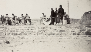 Workers pulling roller to construct a new road, Weihaiwei