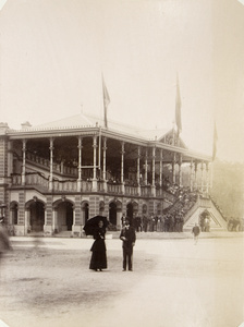 A couple and the grandstand, Happy Valley Annual Race Meeting, Hong Kong