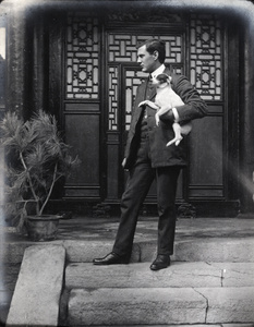 Oliver Heywood Hulme holding a dog