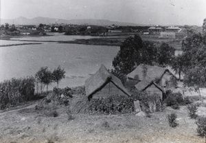 Farm buildings beside a lake