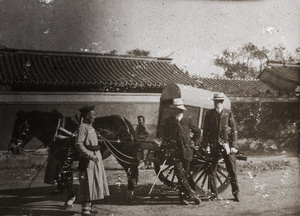 Posing with the driver of a Peking cart