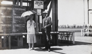 Couple by public stand at the races