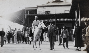 A man posing with a racehorse, Peking Races, Beijing