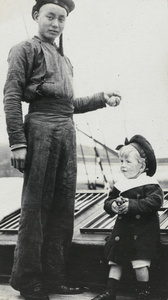 A Chinese man with Alfred Powell on a boat