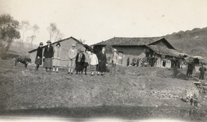 Day trippers, with chair bearers, in a village