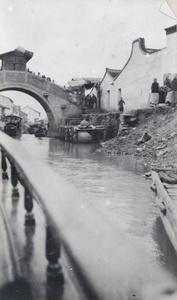 A bridge with a toll booth, photographed from a houseboat