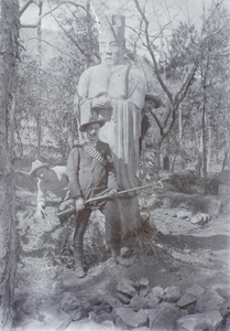 Huntsmen by a stone figure