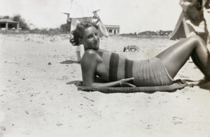 A woman sunbathing on a beach