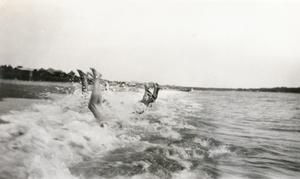 Playing in a wave or surf bathing