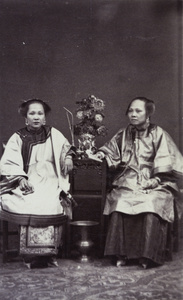 Portrait of two women, with vase, spittoon, paper and pipe