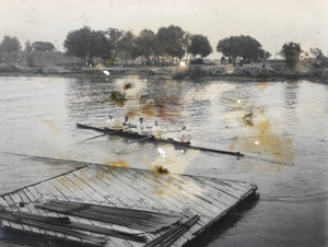 Rowing boat by landing stage, with oars