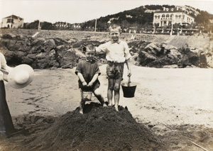Reginald Hutton Potts and George Hutton Potts, on a sand castle, Qingdao