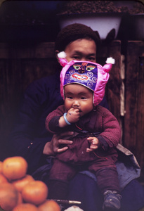 Boy with silk animal-face headwear, Kunming, 1945