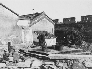 Drawing water from an ancient well, Kowloon, Hong Kong