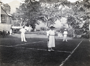 Mr and Mrs Thomson playing a mixed doubles game of tennis, Hong Kong