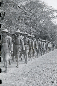 National Army soldiers marching along partly made road