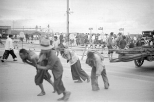 Porters hauling rods across the Bund