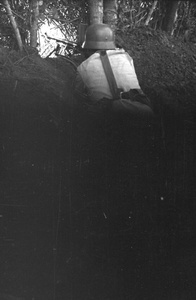 Nationalist soldier in trench, with machine gun