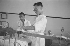 Doctor attending to a patient's foot, Shanghai