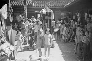 Refugee families and boy scouts in a temple courtyard, Shanghai