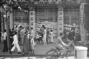 Papers for sale outside hairdressers, Shanghai