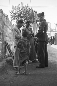 Street seller, onlookers and American marine, Shanghai