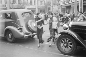 Two women crossing the street outside Van Shing & Co., Avenue Joffre, Shanghai