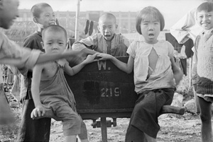 Children playing on a wheelbarrow, Shanghai