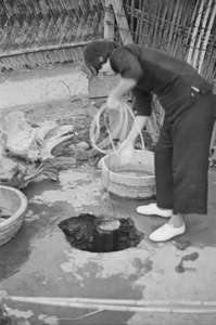 Woman drawing water from a well, Shanghai