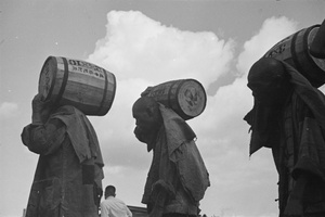 Stevedores loading barrels, Shanghai