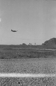 Aeroplane in flight, near an airfield