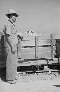 Cement factory worker and truck on rails, Kaohsiung, Taiwan