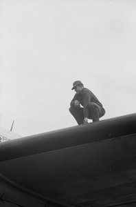 Ground crew man, Civil Air Transport airplane