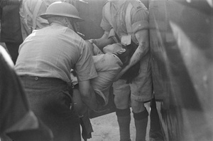 Soldiers carrying an injured woman, Shanghai