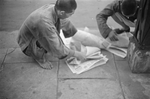 Men with printed posters or newspapers, Shanghai