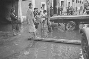 People and flatbed truck in flooded street, Shanghai