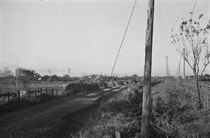 Sandbagged defences by dismantled railway track, Shanghai