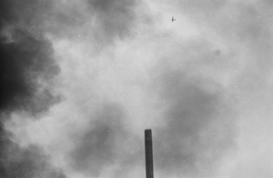 Plane flying over factory on fire, Shanghai