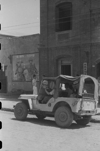 Jeep near propaganda poster