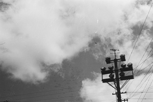 Airplane flying high above a weather vane and floodlights, Shanghai