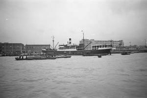 The WAN HSIANG, a San Peh S.N. Co. ship, and warehouses, Huangpu River, Shanghai